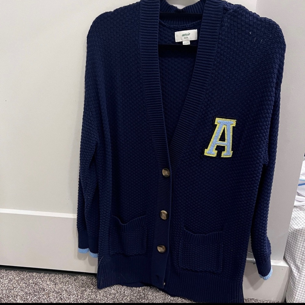 A blue cardigan with long sleeves,